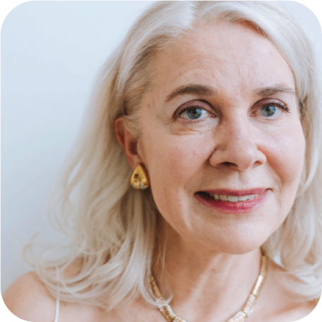 older woman with white hair who is smiling